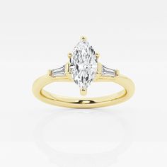 a yellow gold engagement ring with an oval cut diamond and baguettes on the side