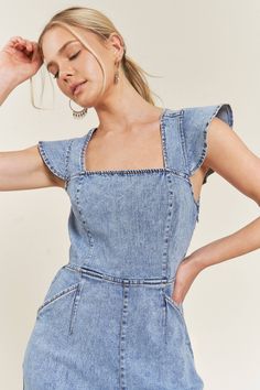 CUTENESS OVERLOAD! This wide leg denim jumpsuit is perfect for spring and summer, with playful tie details, smocked backing, and ruffle sleeves. Don't miss out on this must-have piece! Fits true to size Trendy Spring Jumpsuits And Rompers With Square Neck, Trendy Square Neck Jumpsuits And Rompers For Summer, Casual Cotton Jumpsuits And Rompers With Ruffles, Fitted Short Sleeve Overalls For Summer, Spring Denim Blue Short Sleeve Overalls, Trendy Ruffled Jumpsuits And Rompers For Day Out, Spring Dark Wash Short Sleeve Jumpsuits And Rompers, Spring Short Sleeve Denim Blue Overalls, Trendy Summer Denim Dress With Ruffles