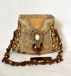 Vintage Mary Frances handbag as beautiful as the day it was purchased but never worn. Fabric tones are soft gold tones and olive green with pearl like decorations adorning the sides with additional topaz tone beading, etc. Measurements are 6 1/2" high from center top to base, 8" across the horizontal bottom, strap measured from top center to side 11" per side approx. width of strap measures 1". Made in the Philipines, additional pat. slip on inner lining. Please email with questions, Free shipping. Vintage Gold Shoulder Bag With Gold-tone Hardware, Designer Gold Pouch Shoulder Bag, Luxury Gold Handheld Shoulder Bag, Vintage Gold Crossbody Bag, Vintage Gold Shoulder Bag For Party, Vintage Gold Shoulder Bag For Formal Occasions, Gold Crossbody Shoulder Bag For Formal Events, Gold Crossbody Shoulder Bag For Formal Occasions, Gold Handheld Shoulder Bag For Evening