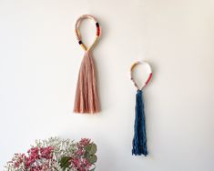 This pair of fringed wall hangings in a loop shape offers a unique mural decoration for your home. If you're in search of an original fiber wall art for your interior, this set of 2 rope wall tassels in complementary colors (pink and teal macrame ends) combines texture, a boho-chic elegance, and a soft touch. They are easy to hang in any space you want to adorn since they are very lightweight wall hangings, easy to mount in the room of your choice. Choose them for yourself or to make a meaningfu Rope Wall Art, Yoga Rope Wall, Rope Animal Nursery Wall Art, Coral Macrame, Rainbow Rope Wall Hanging, Unique Murals, Fiber Wall Art, Macrame Knot, Complementary Colors