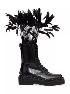 The Valentino Rockstud M-Way Combat Boot in Calfskin with Feathers 50mm merges edgy design with luxurious details. Crafted from calfskin, these combat boots feature the iconic Rockstud embellishments, adding a signature Valentino touch to the rugged silhouette. The standout feature of these boots is the addition of feathers, which lend a unique and extravagant element to the design, creating a striking contrast with the utilitarian aesthetic. With a 50mm heel height, these boots offer both height and comfort, making them suitable for all-day wear. Whether paired with jeans and a leather jacket for a rebellious look or with a dress for a fashion-forward ensemble, the Valentino Rockstud M-Way Combat Boot exudes effortless cool and undeniable style. Most Popular Shoes, Chunky Loafers, Popular Shoes, Valentino Rockstud, Combat Boot, Valentino Garavani, Trending Shoes, Womens Shoes Sneakers, Side Zipper