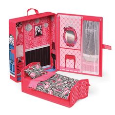 a pink doll house with a bed and furniture in it's open door area