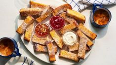 a white plate topped with french toast and ketchup on top of a table