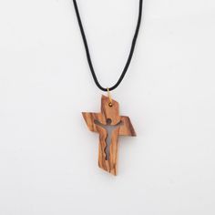 This Christian Necklace with Cross is an ideal gift for Catholics of all ages. Its handmade olive wood from the Holy Land creates a timeless and meaningful piece of faith jewelry that your recipient will cherish. The artisans are Christian, meaning your purchase will help support their work. This is a meaningful gift that's sure to inspire. Dimensions: L 1.2" x W 0.2" x H 1.6" Description: Small and yet boundless this cross represents all the faith you feel. Made from the finest olive wood in Be Spiritual Natural Color Necklaces As Gift, Artisan Necklaces In Natural Wood As Gift, Artisan Necklace In Natural Wood As A Gift, Natural Spiritual Jewelry As A Gift, Artisan Natural Wood Necklaces For Gift, Artisan Natural Wood Necklace As A Gift, Spiritual Natural Wood Necklaces As Gift, Spiritual Natural Wood Jewelry Gift, Spiritual Natural Wood Necklaces For Gifts