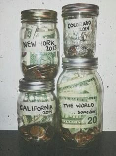 three jars filled with money sitting on top of a table