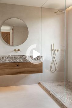 a bathroom with a sink, mirror and shower stall in it's own area