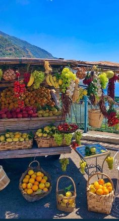 an outdoor fruit stand with lots of fruits