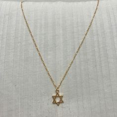 A beautiful and dainty Goldfilled Star of David Necklace.  The chain is goldfield and the Star of David is Gold plated with high-quality 2-micron gold. The Star of David (also known as "Magen David" or "Shield of David") is an ancient Jewish symbol that is known from the holy bible and known as a symbol for self-protection. A beautiful piece to add to your personal collection or to give as a special gift. ❤𝗠𝗘𝗔𝗦𝗨𝗥𝗘𝗠𝗘𝗡𝗧𝗦 ❤ Pendant length: 0.47" / 1.2 cm Pendant with: 0.47" / 1.2 cm Made of high-quality 24k gold plated brass. Please choose your preferred length from the list above. ❤ 𝗠𝗬 𝗦𝗧𝗢𝗥𝗘 ❤ Feel free to take a look at my shop (below) for more beautiful items and inspiration. Back to my shop:  https://etsy.me/2ZBJCus ❤ 𝗔𝗕𝗢𝗨𝗧 𝗠𝗬 𝗟𝗜𝗧𝗧𝗟𝗘 𝗦𝗧𝗢𝗥𝗘 ❤ *If you ha Gold Star Of David Charm Necklace With Delicate Chain, Gold Star Of David Charm Necklace As Gift, Gold Star Of David Charm Necklace For Gift, Gold Minimalist Star Of David Charm Necklace, Minimalist Gold Necklace With Star Of David, Dainty Star Of David Necklace With Adjustable Chain, Gold Star Of David Spiritual Necklace, Gold Star Of David Necklace, Magen David Necklace