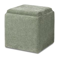 a small square ottoman in green fabric