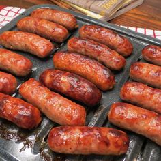 there are many sausages on the grill ready to be cooked