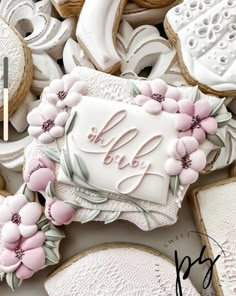 decorated cookies with the word hello baby written on one side and flowers in the middle