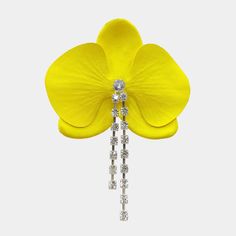 a yellow flower with diamonds hanging from it's back end, in front of a white background