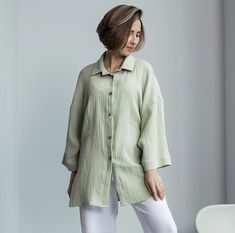 Elevate your everyday ensemble with our Muslin Shirt with Long Sleeves. Designed for the modern woman, this Crinkle Cotton Blouse is both functional and fashionable. Its lightweight gauze fabric offers unbeatable comfort, making it a must-have for all seasons. The subtle texture of the crinkle cotton adds depth and sophistication, while the relaxed fit ensures ease of movement. Paired with jeans, trousers, or skirts, our Gauze Loose Top stands out as a versatile staple in every wardrobe. Step out with confidence and grace in a shirt that epitomizes timeless style. * Made from European muslin (100% cotton) * OEKO-TEX certified fabric (no harmful chemicals used in production) * From XS to Plus size TAKING CARE: * machine wash gentle (30- 40 C/ 104 F) * dry gentle. * do not bleach. Each order Muslin Shirt, Crinkle Cotton, Loose Top, Blouse For Women, Gauze Fabric, Cotton Blouse, Loose Tops, Harmful Chemicals, Cotton Blouses