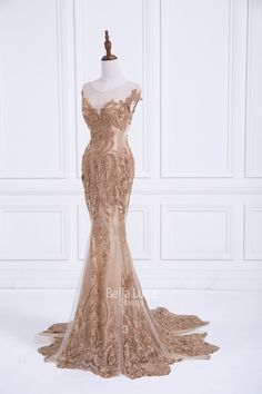 a dress on a mannequin with gold lace and sequins in the back