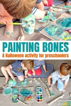 two children are painting bones on the floor with paintbrushes and paper machs