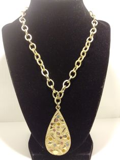 "This is a Vintage Sarah Coventry gold tonesigned necklace. It has a textured teardrop shaped pendant that has colored rhinestones a smooth raised geometric shapes on it. The chain consists of chunky,  lightweight , part textured and part smooth oval links and is 18\" long with a large spring ring clasp." Metal Teardrop Pendant Necklace, Gold Metal Teardrop Drop Necklace, Gold Teardrop Metal Drop Necklace, Gold Teardrop Metal Necklaces, Gold Teardrop Metal Necklace, Gold Bohemian Teardrop Pendant Drop Necklace, Bohemian Gold Teardrop Pendant Drop Necklace, Bohemian Gold Teardrop Pendant Necklace, Gold Teardrop Chain Drop Necklace