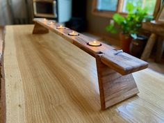 three candles are lit on a wooden table