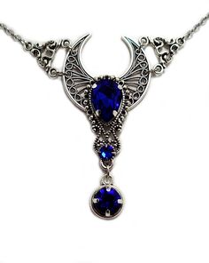 "This is a new handmade necklace. It is made with antiqued silver plated filigrees, accented with high quality DARK SAPPHIRE BLUE glass rhinestones. Decorated portion is 2 3/8\" wide and 2 1/2\" tall in the center. Necklace is adjustable 15-18\" with a lobster clasp and chain extender. If you would like a different length, please send us a message. Matching headpiece and earrings are listed in our store." Blue Gothic Metal Necklace, Gothic Blue Metal Jewelry, Blue Gothic Metal Jewelry, Blue Festival Jewelry With Moon Charm, Blue Jewelry With Moon Charm For Festival, Festival Jewelry With Blue Moon Charm, Festival Blue Jewelry With Moon Charm, Blue Bohemian Necklace With Intricate Design, Bohemian Blue Necklace With Intricate Design