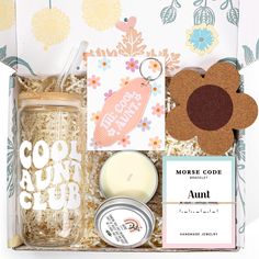 an open gift box with candles, cards and other items