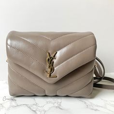 Saint Laurent Toy Loulou Condition: Excellent Exterior: No Major Flaws Present. Leather Wrinkling Present Due To Normal Use. Faint Hairline Scratches On Front Hardware. Metal Darkening Present On Snap Closure, Strap Loops, And Clasps Due To Normal Use. Interior: Leather Wrinkling Underneath Flap. Interior Lining Is In Excellent Condition, Shows Minimal Signs Of Use. No Major Rips Nor Odors Present. Includes: Dust Bag, Detachable Non-Adjustable Strap, And Brand Booklet Color: Taupe Features: Snap Ysl Toy Loulou, Ysl Toy, Saint Laurent Toy Loulou, Saint Laurent Paris, Saint Laurent Bag, Gorgeous Bags, Classic Mini, Fashion Handbags, Ysl Bag