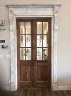 a wooden door with two glass panels in a room