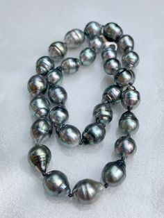 Large, Baroque, Circled, Tahitian Pearl Necklace This necklace is knotted with black thread and finished with a white gold clasp.  It measures 17 inches long. The pearls range from 11-15mm. Very large pearls!  A truly beautiful gift for someone special or for yourself!