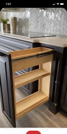 an open cabinet in the middle of a kitchen