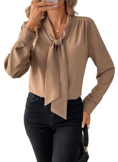 PRICES MAY VARY. Material:made from 100% Polyester,this blouse is crafted from a soft fabric that is incredibly lightweight and flowy,making it comfortable to wear all day Features:this casual blouse has a front bow tie knot style;long sleeves;a V-neckline;solid color;button cuffs.It is perfect for office ladies,makes you stand out in a crowd Matched:this blouse shirt is easy to pair with skirts;jeans;high waist shorts;high-heeled shoes;necklace and earrings,giving you a timeless and stylish loo Blouses For Work Office Wear, Business Blouses For Women, Ladies Work Outfits, Office Tops Blouses Work Wear, Winter Business Casual Outfits For Women, Bank Teller Outfit, Blouse And Skirt Outfit, Tie Knot Styles, Stylish Blouses