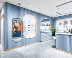 an eye store with blue walls and gold trim