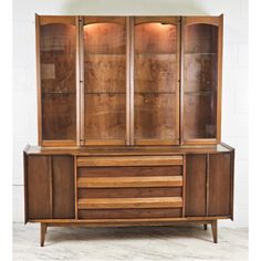 a wooden cabinet with glass doors and drawers