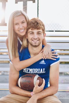 a man and woman sitting on a bench with a football in their lap, smiling at the camera