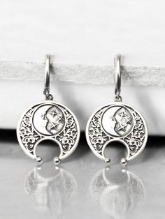 Embrace the mystique of the moon with these stunning half moon earrings. Handcrafted from high-quality sterling silver, these lunula earrings feature an intricate design inspired by Viking jewelry and celestial themes. Perfect for those who love boho style and lunar symbolism, these earrings capture the beauty and mystery of a lunar eclipse. These sterling silver lunula earrings are both elegant and durable, making them ideal for everyday wear or special occasions. The detailed craftsmanship reflects the timeless appeal of Viking jewelry while adding a modern boho twist. Whether you're looking for a unique accessory or a thoughtful gift, these half moon earrings are a perfect choice. Celebrate the celestial charm and Viking heritage with these exquisite half moon earrings. Their handcrafte Celestial Style Pierced Sterling Silver Jewelry, Elegant Moon-shaped Silver Earrings, Elegant Silver Moon-shaped Earrings, Half-moon Metal Earrings With Moon Charm, Silver Moon Phase Dangle Jewelry, Metal Half Moon Earrings With Moon Charm, Half Moon Earrings With Moon Charm, Half Moon Metal Earrings With Moon Charm, Celestial Sterling Silver Jewelry With Matching Earrings