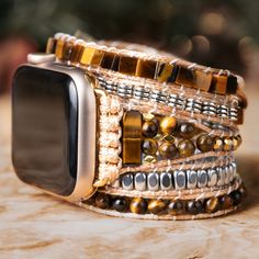 Adding a touch of elegance and nature to your Apple Watch, this Treehut watch strap features semiprecious tiger eye stones, a stone that exudes an air of mystery and romance, and metal accents with stunning golden-brown hues and mesmerizing chatoyancy. The stone's silky smooth texture and intricate patterns create a sense of depth and movement, like a glimpse into a hidden world of magic and enchantment. *Strap only; Apple Watch not included. Please check the back of your Apple Watch to make sur Brown Rectangular Jewelry, Bohemian Silver Watch Bands With Bracelet Strap, Bohemian Silver Bracelet Strap Watch Bands, Luxury Adjustable Apple Watch Band For Gift, Luxury Handmade Adjustable Watch Accessories, Luxury Adjustable Stainless Steel Apple Watch Band, Trendy Brown Bracelet Strap Watch Band, Trendy Brown Watch Band With Bracelet Strap, Luxury Handmade Adjustable Watch Bands