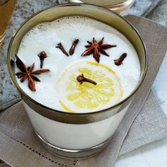 there is a drink with orange slices and spices in it