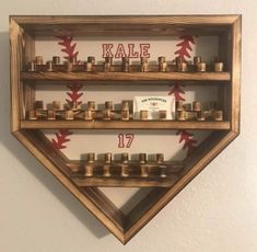 a baseball themed wall shelf with candles in it