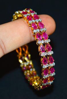 "1 solid 18k gold 10.35cts diamond and ruby bangle f-g color and vs clarity untreated natural diamonds and untreated natural pinkish red rubies. extremely high end - top quality bangle (i have 2 bangles, but this listing is of one bangle. please contact me if you are interested in both bangles) here is the description of one bangle: this is a custom made top quality ruby and diamond bangle. the bangle is loaded with 1.71cts of round brilliant cut diamonds and 22 pear cut natural red rubies total Ruby And Diamond Bangles, Diamond Bangle In Yellow Gold For Party, Yellow Gold Diamond Bangle For Party, Elegant Diamond Bangle With Gemstones, Party Yellow Gold Diamond Bangle, Diamond Bangle With Single Cut Diamonds, Elegant Ruby Bangle With 17 Jewels, Exquisite Diamond Bangle, Diamond Prong Setting Bangle Gift