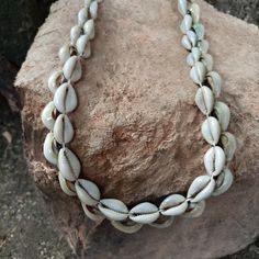 This listing is for an original handmade Cowrie / Cowry shell Turkana tribe unisex 2-strand necklace.  Each is made in the Lokitaung region near Lake Turkana, Kenya...located just south of Ethiopia.  Made from traditional cowry shells & white poly-cord from a gurney sack.  Item measures appx: 18-30 Inch total length.  YOU SELECT LENGTH AT CHECKOUT. CONTINUOUS 2-LAYER,... item as shown.  Weight is appx: 80-150 grams.   --Striking piece matches anything and looks great on anyone, anytime,... anypl Artisan Beaded Necklace In Natural Color For Beach, Bohemian Strand Shell Necklace For Festivals, Traditional Cowrie Shell Jewelry For Beach, Traditional Handmade Necklaces For Vacation, Artisan Fair Trade Necklaces For Beach, Artisan Shell Necklace For Beach, Bohemian Shell Choker, Fair Trade Natural Necklaces For The Beach, Natural Fair Trade Necklaces For The Beach