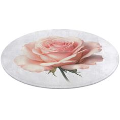 a pink rose sitting on top of a white plate