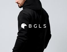 a man wearing a black hoodie with the words bgl's on it