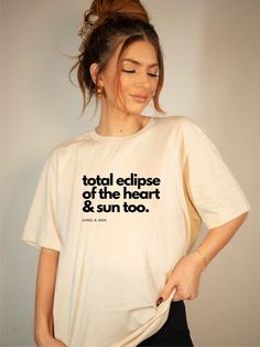 a woman wearing a t - shirt that says total eclipse of the heart and sun too