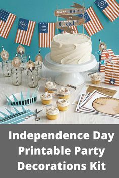 a table topped with cupcakes and cake next to flags