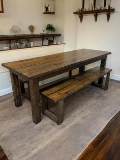 a wooden table and bench in a room