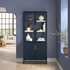 an empty room with blue walls and shelves filled with books, vases and other items