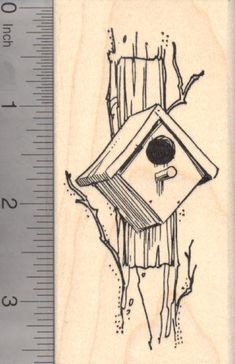 a rubber stamp with a birdhouse on it