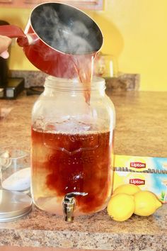 a person pours liquid into a mason jar