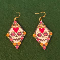 two pairs of beaded earrings with hearts on them