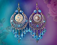 "'Make some time for the sunshine!'  These Celestial Boho Chandelier Earrings are made with plated brass Sun & Moon stampings hanging from intricate crescent filigrrees. Bright Aqua Blue crystal beads and crystal rhinestones add a beautiful sparkle!  Available in Posts, Leverbacks, Clip-Ons or French Wires. -3 1//2\", includes piercing x 1 1/2\" Wide -0.2-0.3 oz. ea. Metal Finiahes Available: -Bronze (as pictured) temporarily sold out -Silver (6'th image) *Many Colors Available in the Pull-Down Handmade Blue Chandelier Earrings For Festival, Bohemian Blue Chandelier Earrings As Gift, Bohemian Blue Adjustable Chandelier Earrings, Blue Dangle Chandelier Earrings For Festival, Blue Bohemian Chandelier Earrings For Festival, Nickel-free Light Blue Bohemian Jewelry, Bohemian Light Blue Nickel-free Jewelry, Light Blue Bohemian Dangle Jewelry, Celestial Boho