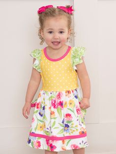 Get ready for some serious cuteness with our Wildflowers & Yellow Dots Sister Set! Made from soft and lightweight fabric, this dress features a fun ruffle hem, adorable yellow dots, and a charming wildflower print. Perfect for any occasion, your little one will look oh-so-adorable and feel comfortable all day long. Fits true to size. Body: 95% Polyester / 5% Spandex Combo: 97% Cotton / 3% Spandex Accessories sold separately. Suggest bow color #35 and #67 Import. Aurora is 31 inches tall and 25 l Wildflower Print, Xxxl Dress, Dresses Xxl, Toddler Girl Dresses, Xl Dress, Ruffle Hem, Ruffle Dress, Dresses Xs, Lightweight Fabric