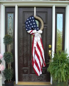 an american flag wreath hangs on the front door