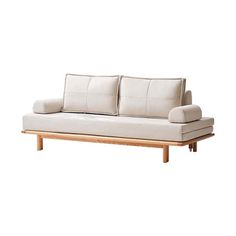 a white couch sitting on top of a wooden frame